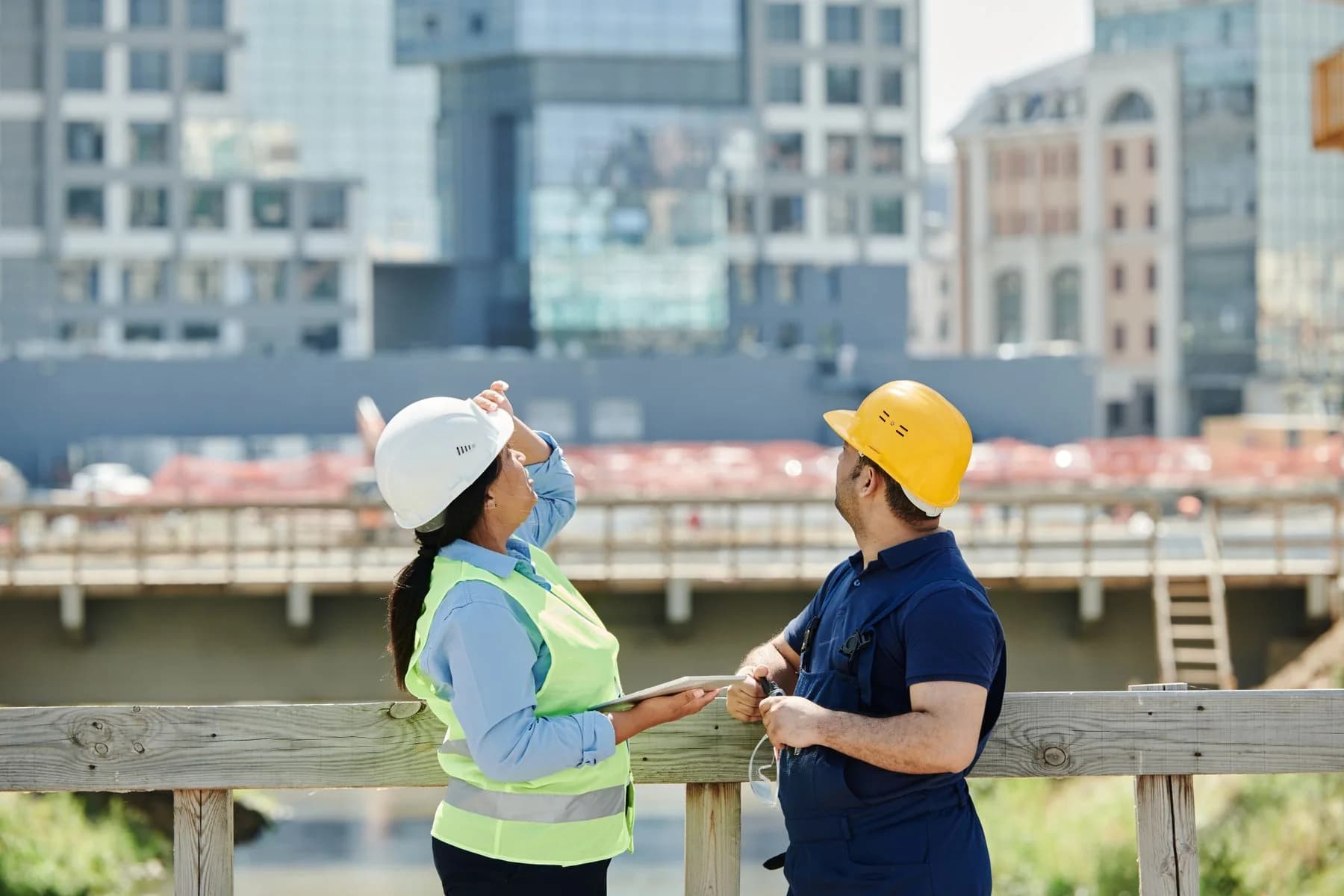 Construction engineers assessing project requirements at a professional building site